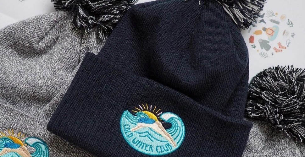 Join the Cold Water Club and keep your head warm with a cosy bobble hat from the Black Pug Press